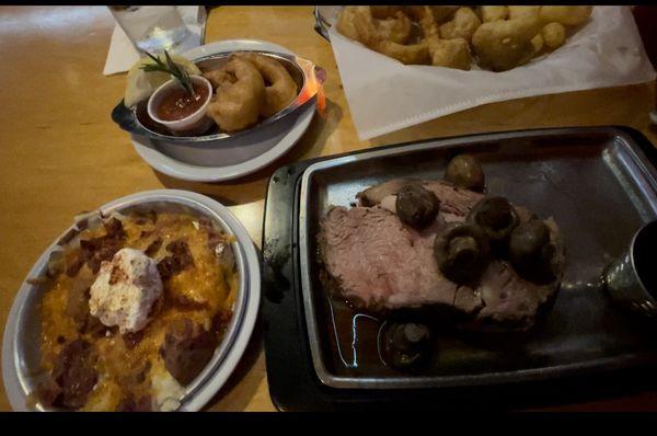 Prime rib with mushrooms on top, smashed red potatoes and 3 shrimp