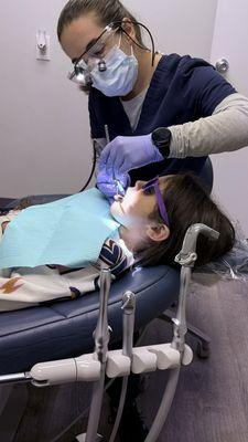 Child getting a cleaning.