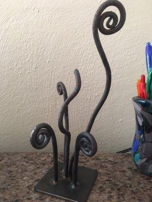 Cute curly q art piece my dad and I made during a beginner's blacksmithing class! Sits on my desk