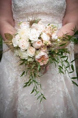 Soft peach and white bridal bouquet featuring garden roses, roses and spray roses, stock, gilded foliage.