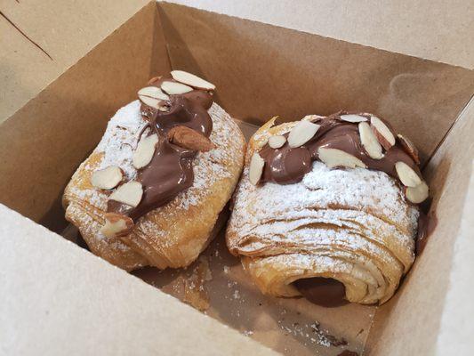 Croissant filled with hazelnut spread, topped upon request.