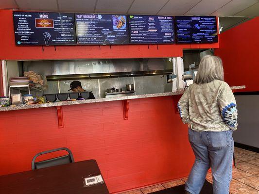 Menu above and the kitchen area