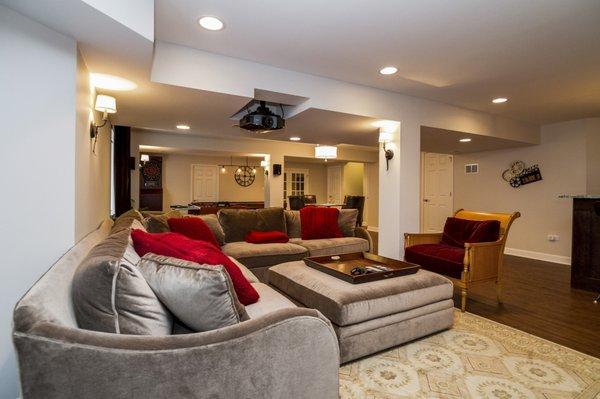 A basement remodel is the perfect way to entertain the entire family.  Especially with a built-in projector and big screen.