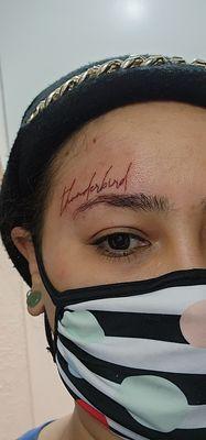 Aubrey did a font script in red ink "thunderbird" over my right eyebrow