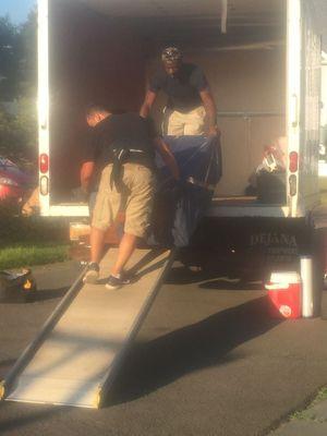 The team unloading furniture of the truck