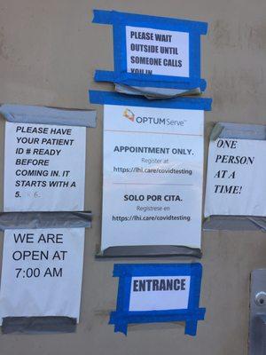 Signs on the outside of the testing building.