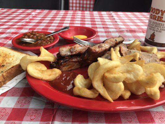 Spare ribs with pork, fries, baked beans, a piece of garlic toast, and sweet tea