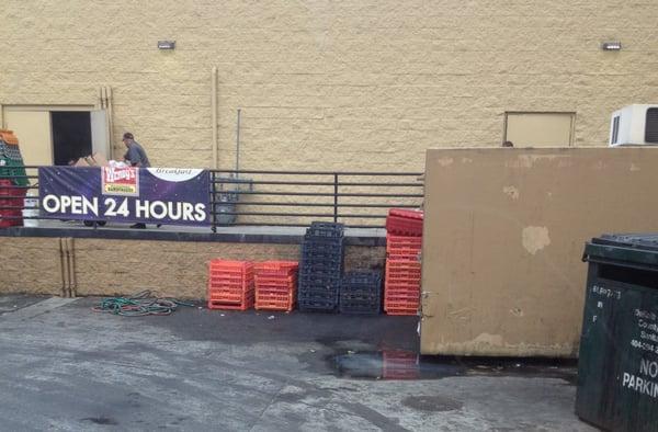 Bread crates near leaking trash bin