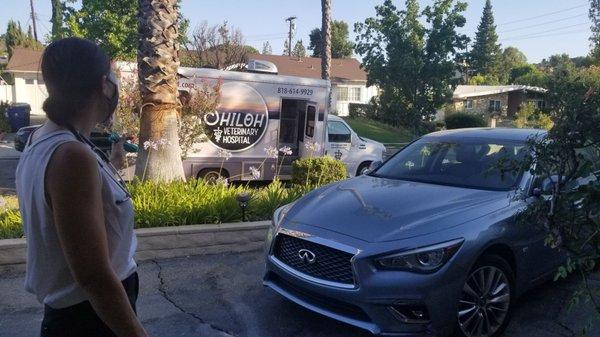 Dr Anderson standing outside at 110 degrees waiting for our puppies to come out of the van.