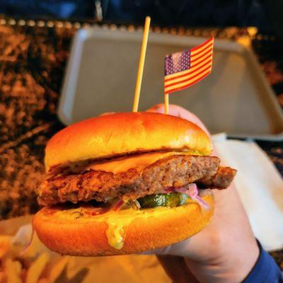 Cheeseburger with Impossible patty, complete with American flag, "cuz you're in America!"