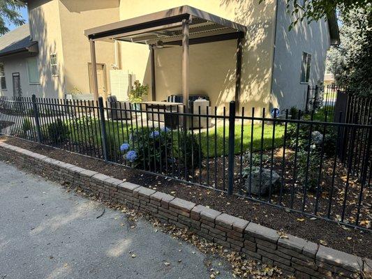 Retaining wall, plants, sod.