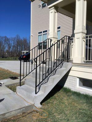 Concrete steps and wrought iron rails