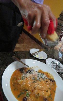 Server Bob with freshly grated cheese on our main courses.