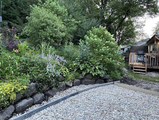 After: before the concrete was poured they leveled and graded everything and prepped the site. Original retaining wall exposed properly.