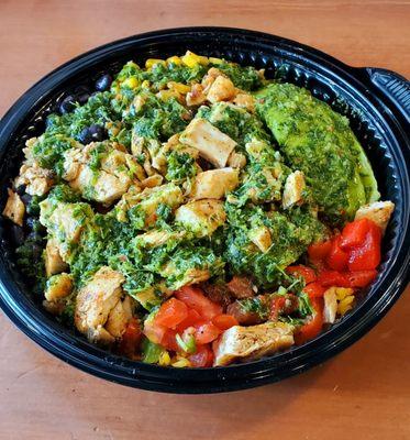 Portuguese Rice Bowl. Chicken, rice, avocado, grilled corn, black beans, red peppers, and then covered with chimichurri sauce. Delicious.