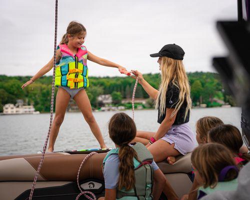 Pro wakesurfer coaching the next generation of kids how to Wakesurf and have fun on the water