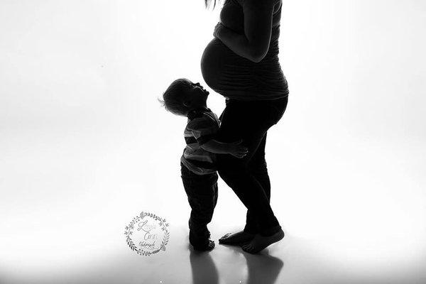 Maternity silhouette with mother and son taken in studio, Goshen, IN.