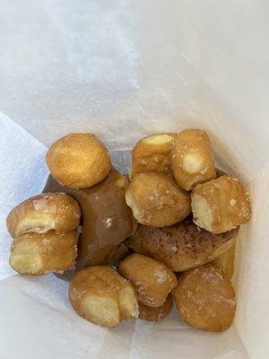 A half dozen donuts with a handful of donut holes to go with my order.  Enough donut holes that it almost covers the donuts.