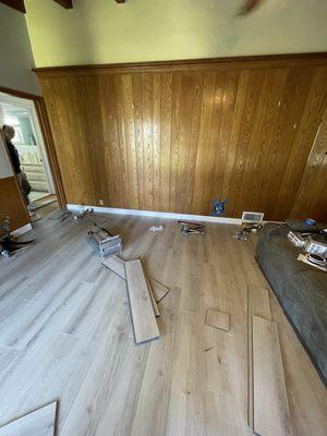 Installing new flooring in the living room and baseboards