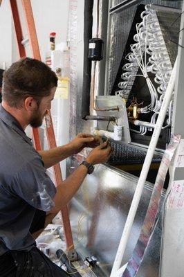 An Air & Energy technician installs a brand new Trane air conditioning system.