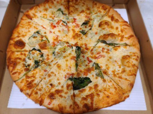 Ultimate white: white pie with ricotta cheese, baby spinach, artichoke hearts, and diced tomatoes.