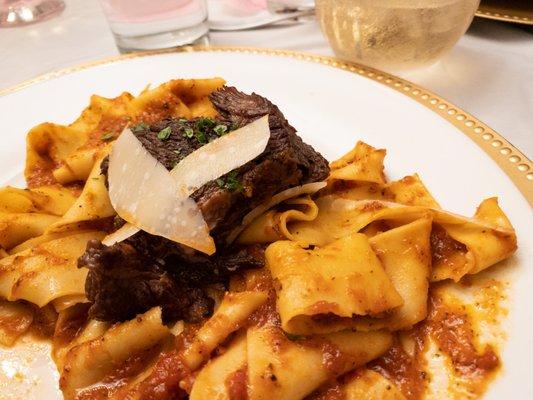 Red Wine Braised Short Rib Pappardelle with
 handmade pasta, San Marzano tomato sauce, fresh shaved parmesan