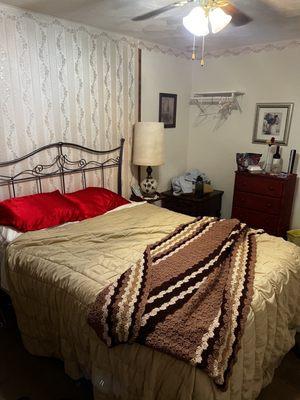 Double bed with old bedding.