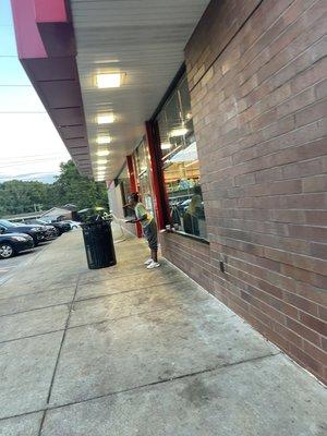 The front of Quiktrip. This young lady is always there begging.