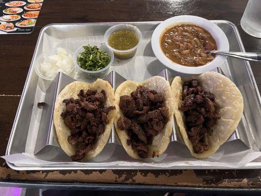 Three beef tacos I didn't order.  Beef was rubber-tough. Price with water plus tip? $15. Pricey.