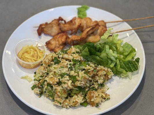 Nam Khao broken rice combination with chicken on a stick