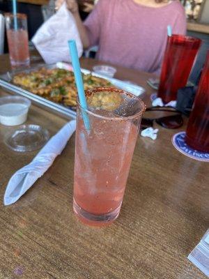 Sandia spritz with loaded cheese fries in the background!