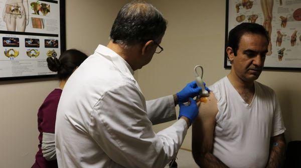 Dr. Moheimani performing a PRP injection to the shoulder. PRP therapy is a form of regenerative medicine that uses the person's own blood.