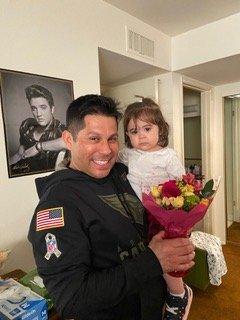 Adam and his daughter delivering flowers to a hospice patient on Saturday