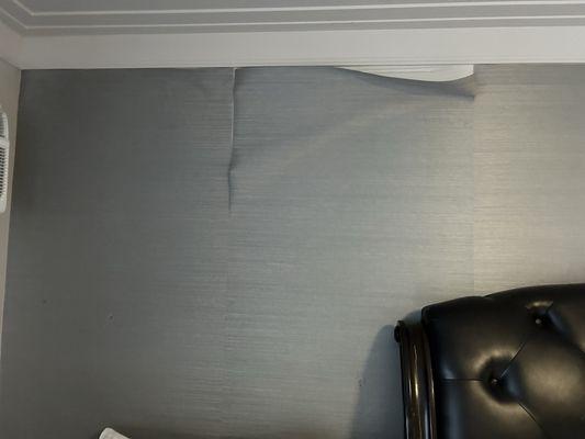 Wallpaper falling off wall.