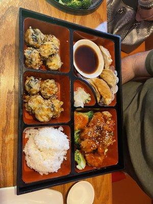 Bento Box with sesame chicken, JB tempura, and gyoza.