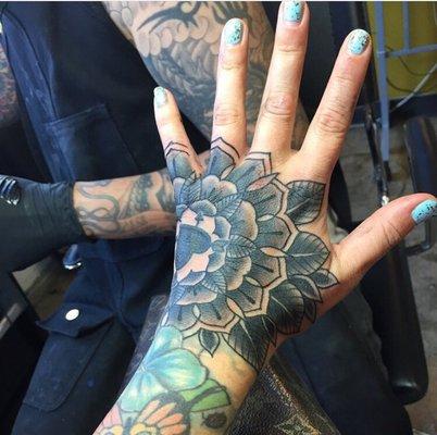 Hand tattoo by Taka