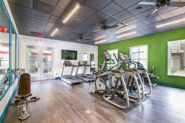 Fitness center with strength training and cardio equipment.