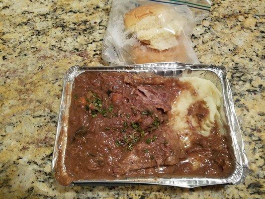 Pot Roast with carrots and mushrooms.  Mash potatoes on the bottom and two dinner rolls in a baggie