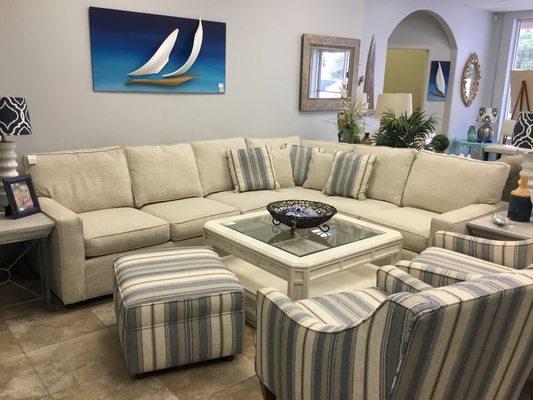 L shaped sectional, with a pair of club chairs and ottoman.