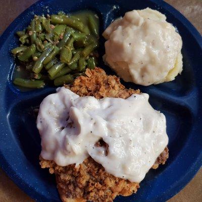 Chicken fried steak, green beans and mashed potatoes and gravey.