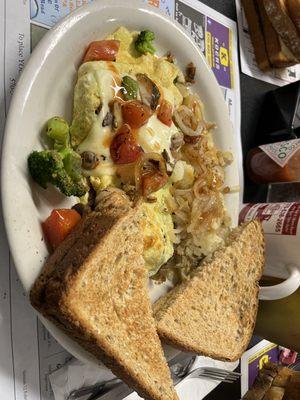 Veggie omelette with home fries and onions with whole wheat toast