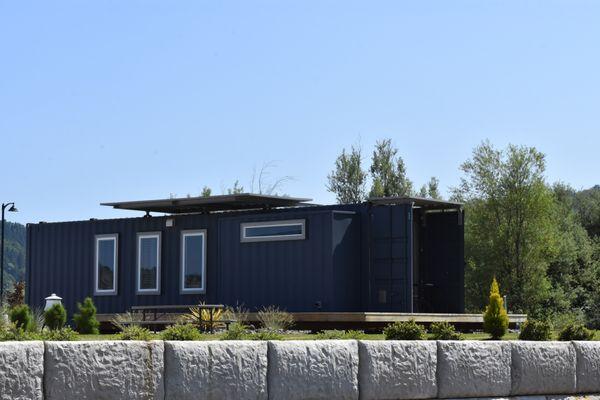 This container has a glass roll up garage door showcasing a   spectacular golf course view!