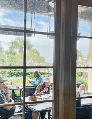 Terrace dining overlooking the Sanctuary Hotel pool and glimpses of the ocean.