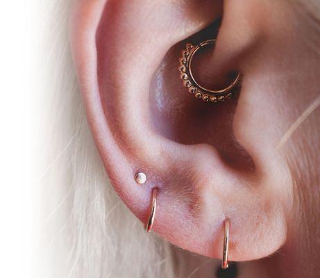 Daith and multiple lobe piercings with rose gold jewelry