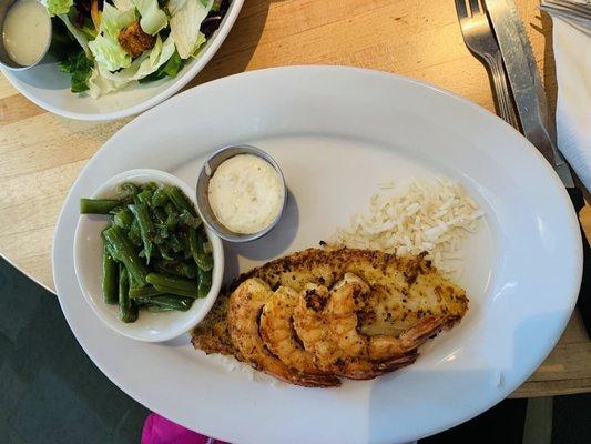 Catfish with baked shrimp on it and beans