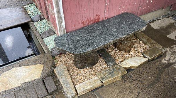 A warm Bench made of Granite materials with more displays of Buckskin and Green Glaciers rocks.