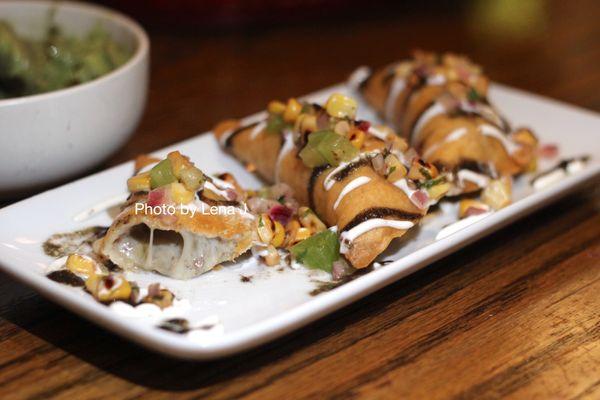 Forest Mushroom Empanadas ($14) - huitlacoche vinaigrette, tomatillo corn salsa, cheese, crema