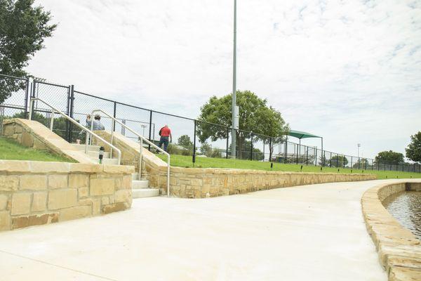 The walking trail surrounding the pond connects to the football fields at Chandler Park, where Mansfield Pee Wee Football plays.