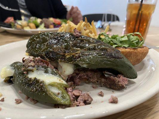 Freshly ground angus beef burger, topped with cheese filled poblano pepper on a homemade, toasted bun.