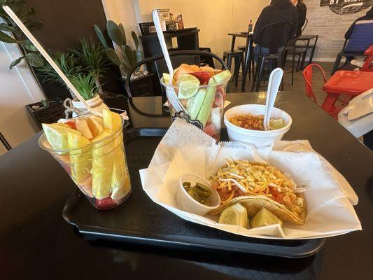 Two fruit bowls-- one large and one small, corn, and veggie taco.